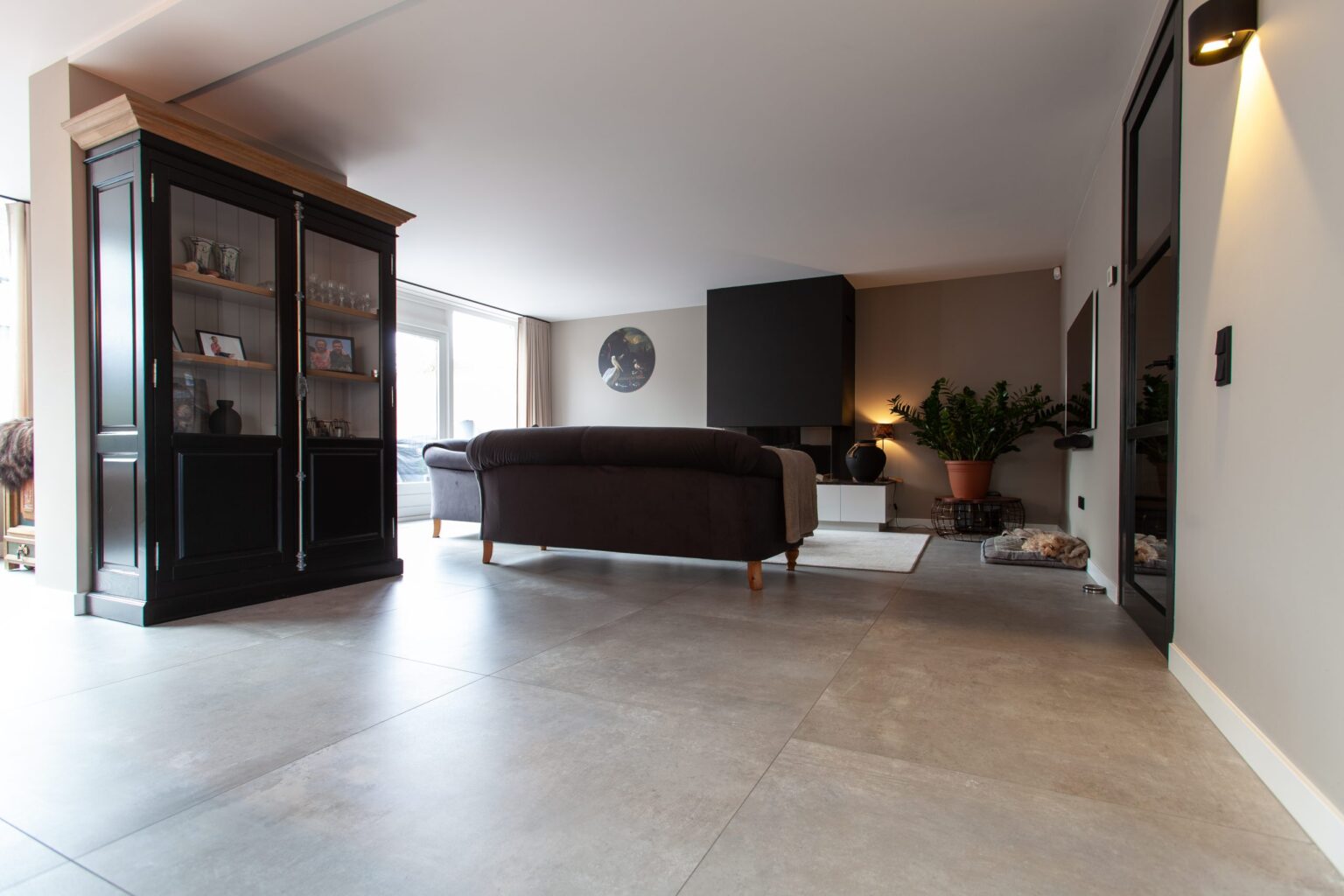 Woonkamer in Noordwijk met grote lichtgrijze betonlook vloertegels van 100×100